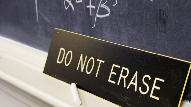 Do not erase sign next to the blackboard